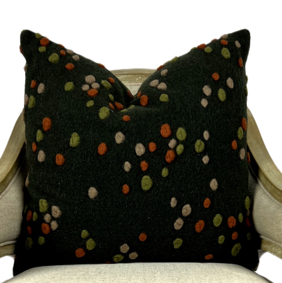 Folksy dark brown wool pillow with autumnal colored bouclé accents.